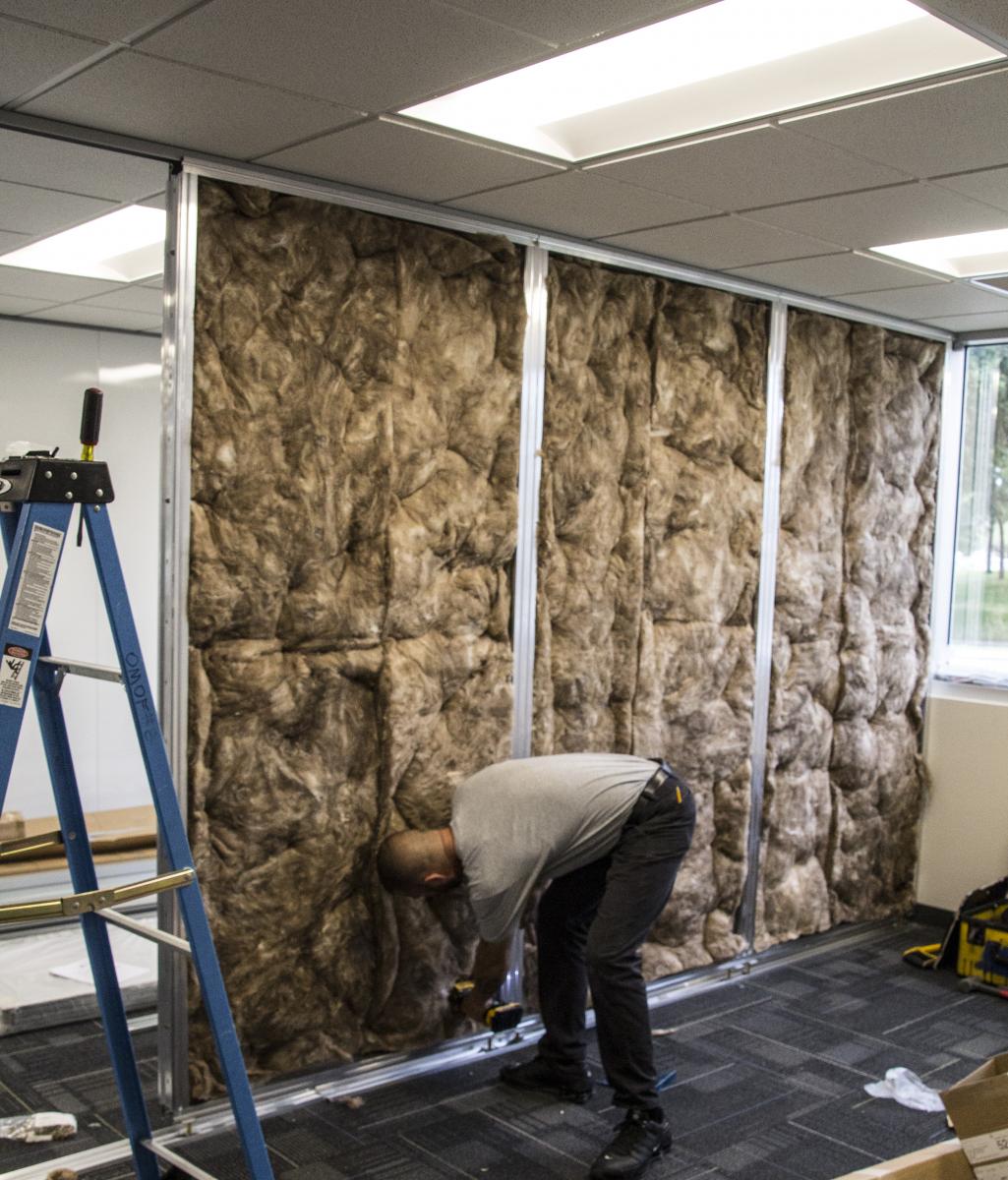 Our certified installer leveling out the Floor-to-Ceiling walls